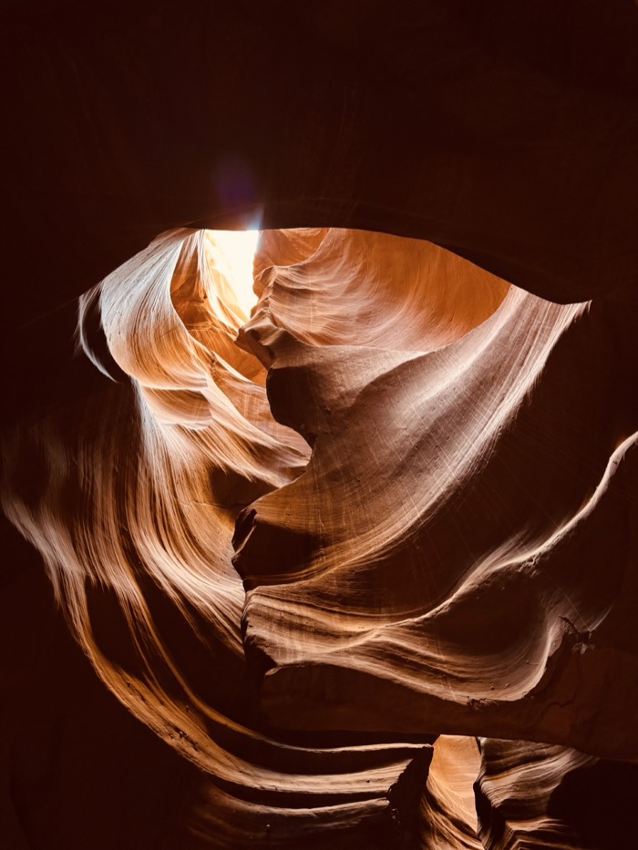 A heart shaped opening in a glowing sandstone canyon
