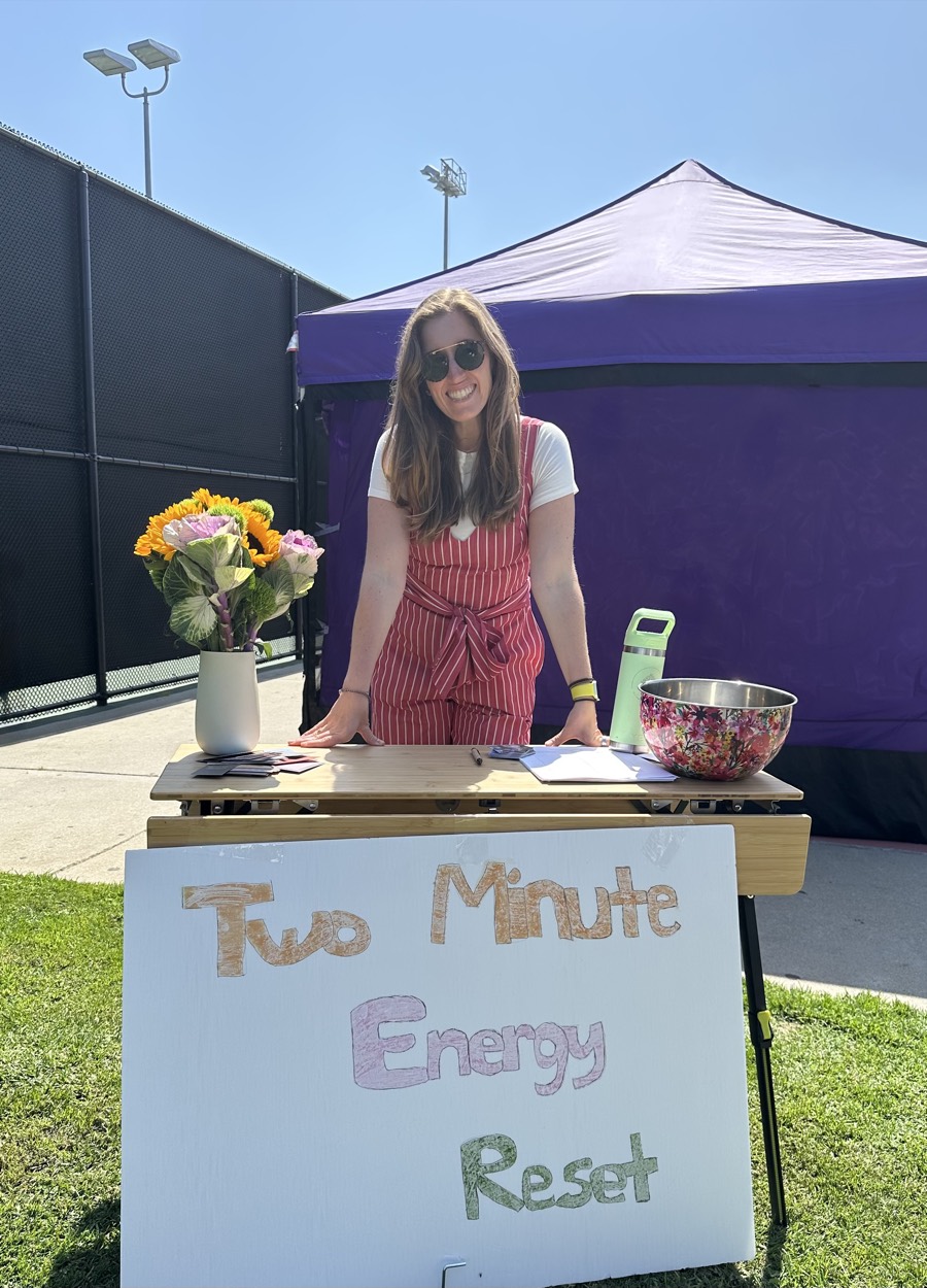 Jenn smiling at her Two Minute Energy Reset booth