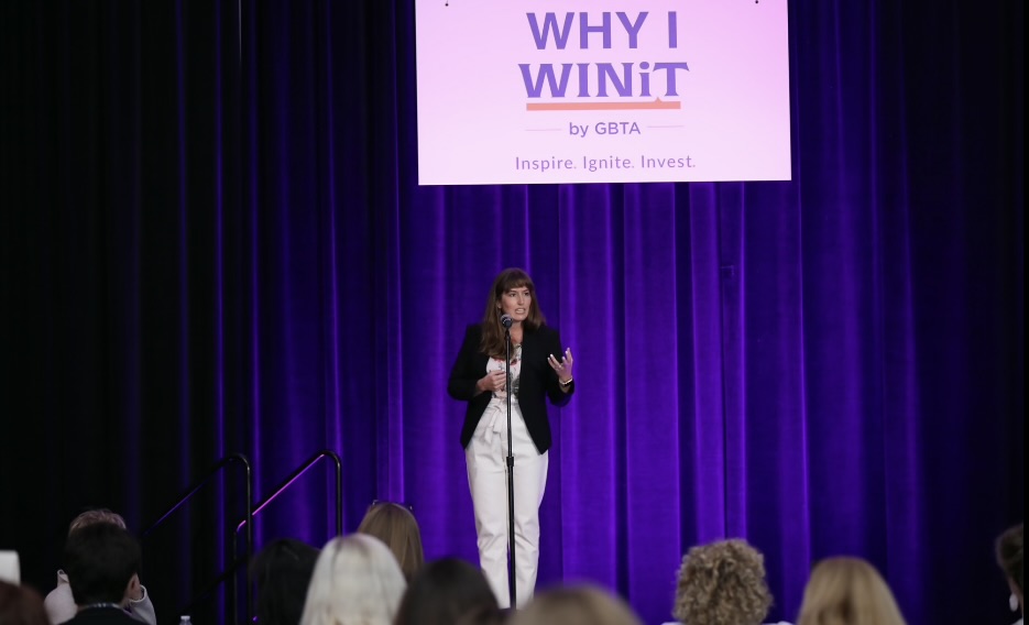Jenn speaking on stage at GBTA's Why I WINiT event